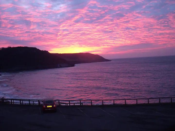 Red skies over Caswell Bay at sunset